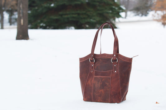 The Leatherbeau er, featuring gold hardware and a spacious interior with multiple compartments.Royal Tote Bag in Red leath